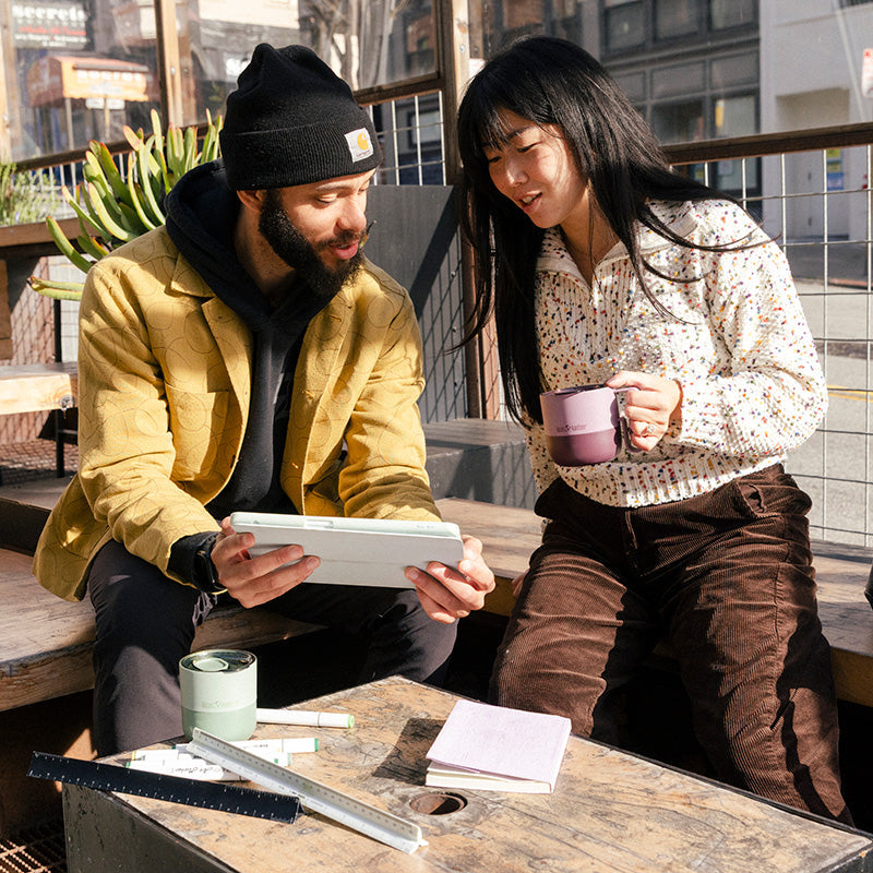 12oz-rise-mug-i9 12oz_rise_coffee_mug_dusty_orchid_couple_city_patio_square.jpg