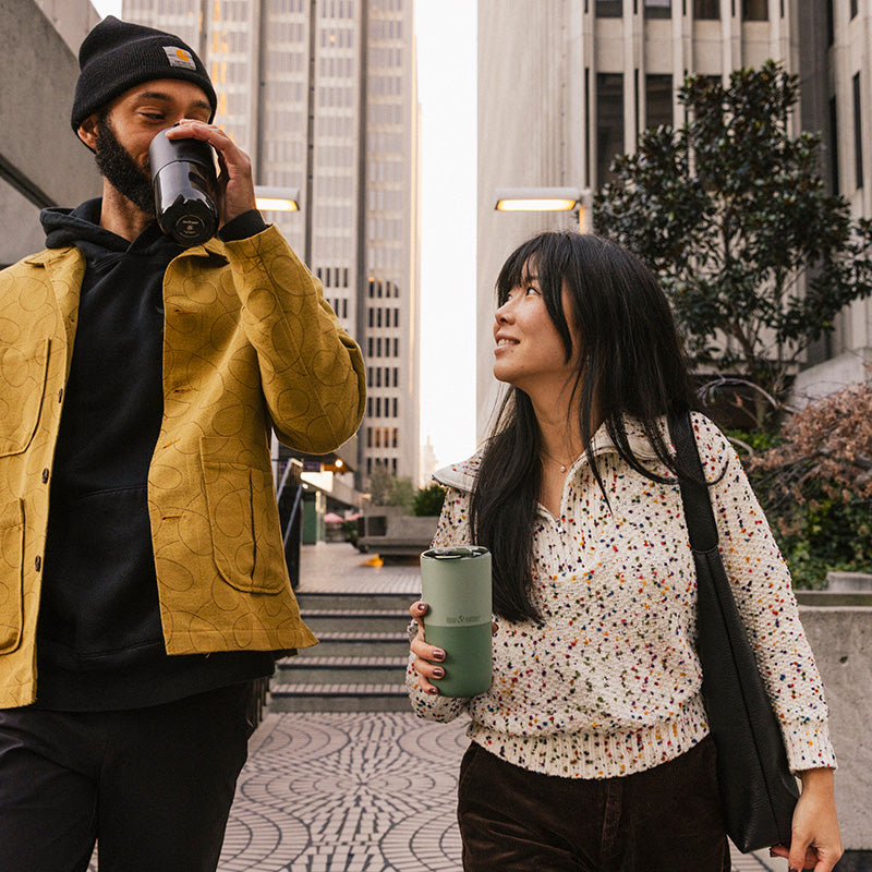 16oz-rise-tumbler-a3 16oz_rise_tumbler_black_iceberg_couple_drink_city_street_square.jpg