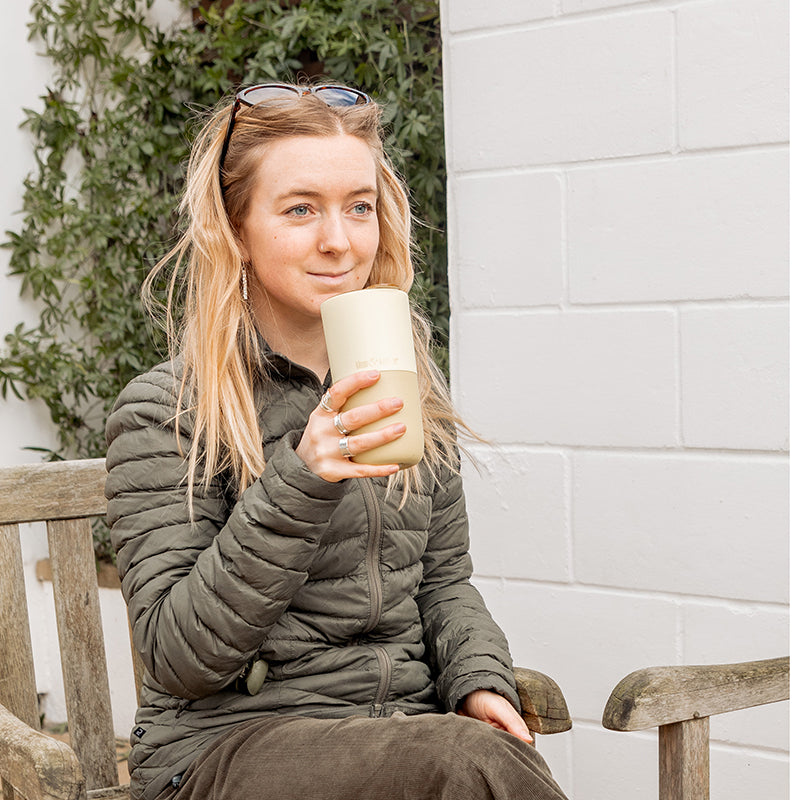 16oz-rise-tumbler-a3 16oz_rise_tumbler_wax_yellow_woman_seat_outside_square.jpg