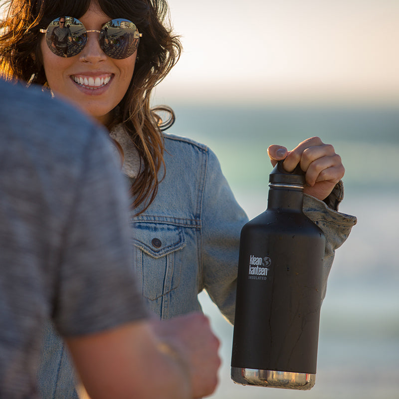 64oz-classic-with-loop-cap-b7 64oz_insulated_classic_black_beach_girl_hand_square.jpg